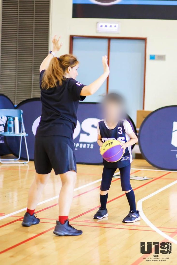Paulina running a basketball drill with a young player