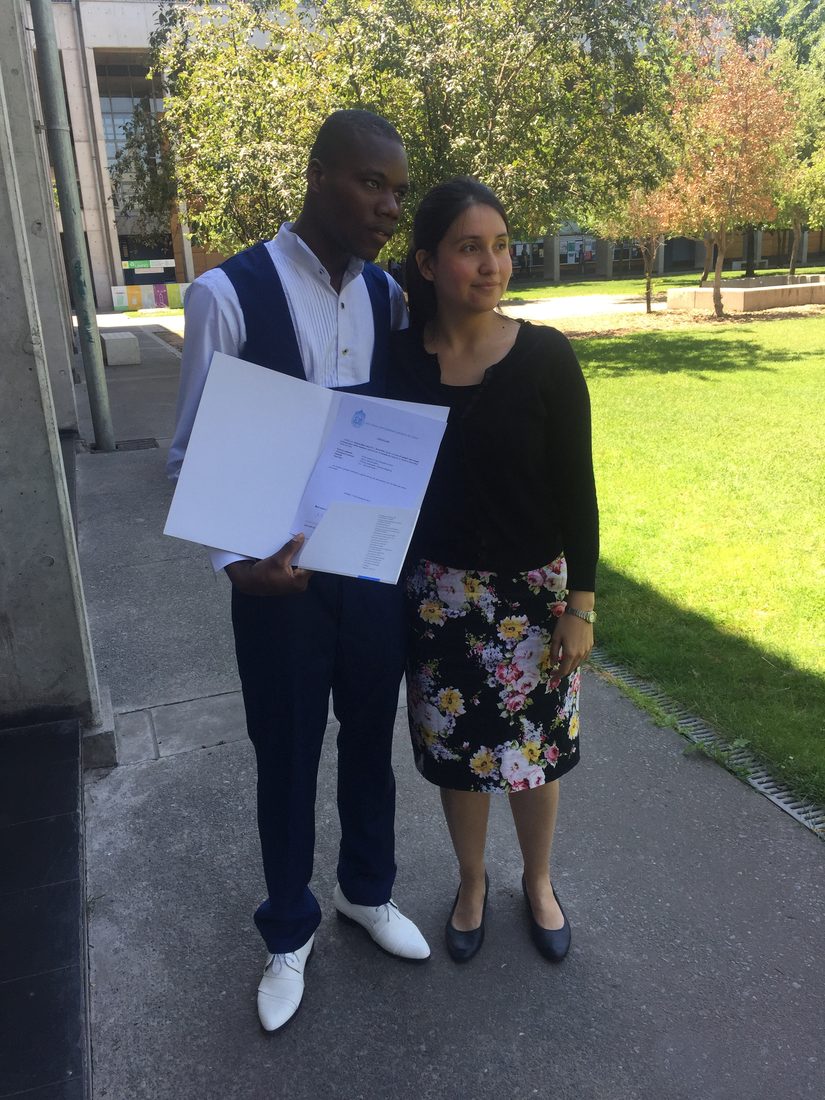 Paulina with a student from the Haitian immigrant Spanish programme, who is holding his certificate